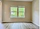 Inviting living room with large windows providing natural light and modern flooring for a comfortable space at 12815 Towering Pine Dr, Charlotte, NC 28269