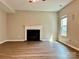 Cozy living room with a fireplace, modern flooring, and a ceiling fan for a comfortable and inviting atmosphere at 12815 Towering Pine Dr, Charlotte, NC 28269