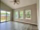 Bright living room with vaulted ceiling, sliding glass doors, and several windows at 12815 Towering Pine Dr, Charlotte, NC 28269