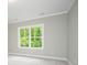 Bedroom with neutral carpet, crown molding and a window providing natural light at 1721 Balfour Ln, Charlotte, NC 28216
