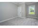 Neutral bedroom with plush carpet, trim and a window providing natural light at 1721 Balfour Ln, Charlotte, NC 28216