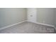 Bedroom features neutral carpet, base trim and a double-door closet for storage at 1721 Balfour Ln, Charlotte, NC 28216