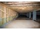 Crawl space with wood framing and vapor barrier ready for finishing at 1721 Balfour Ln, Charlotte, NC 28216