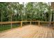 Exterior wooden deck overlooking a green backyard and forest at 1721 Balfour Ln, Charlotte, NC 28216