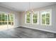 Bright dining area features sliding glass doors leading to a deck and plentiful natural light at 1721 Balfour Ln, Charlotte, NC 28216