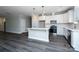 New kitchen boasts white cabinets, stainless steel appliances, and a spacious island with pendant lighting at 1721 Balfour Ln, Charlotte, NC 28216