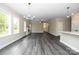 Open-concept living room with fireplace, modern floors, and abundant natural light at 1721 Balfour Ln, Charlotte, NC 28216