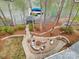 Aerial view of lake house with boat dock and fire pit, offering a serene and luxurious lakeside living at 176 Sunset Bay Dr, Troutman, NC 28166