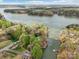 Lakefront property with private docks nestled among mature trees on a peninsula with sprawling lake views at 176 Sunset Bay Dr, Troutman, NC 28166