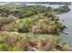 Aerial view of a lakefront home nestled among trees and a private boat dock on a cove at 176 Sunset Bay Dr, Troutman, NC 28166