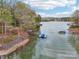 Picturesque waterfront property featuring a private dock, boat slip, and serene lake views at 176 Sunset Bay Dr, Troutman, NC 28166