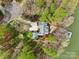 Stunning aerial view of home with lush landscaping, outdoor fire pit, and a private boat dock at 176 Sunset Bay Dr, Troutman, NC 28166