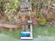 Beautiful lakeside home with private dock, boat slip, and lush natural landscaping at 176 Sunset Bay Dr, Troutman, NC 28166