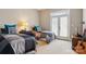 Bright bedroom features two twin beds, stylish zebra-print pillows and a door to the exterior at 176 Sunset Bay Dr, Troutman, NC 28166