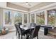 Dining area features modern table, lots of light, and a ceiling fan at 176 Sunset Bay Dr, Troutman, NC 28166