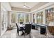 Dining area with modern table, large windows, and a stylish ceiling fan at 176 Sunset Bay Dr, Troutman, NC 28166