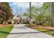 Elegant home with stone accents, manicured landscaping, and a long driveway leading to the residence at 176 Sunset Bay Dr, Troutman, NC 28166