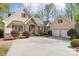 Beautiful home with stone accents and a three-car garage, showcasing curb appeal at 176 Sunset Bay Dr, Troutman, NC 28166