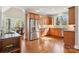 Well-lit kitchen with stainless steel appliances, wooden cabinets, and hardwood floors at 176 Sunset Bay Dr, Troutman, NC 28166