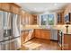 Bright kitchen with stainless steel appliances, wooden cabinets and view to the exterior at 176 Sunset Bay Dr, Troutman, NC 28166