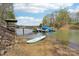 Lake view featuring a boat dock and paddle board for water activities and serene relaxation at 176 Sunset Bay Dr, Troutman, NC 28166