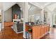 Stylish living room adjoining a wet bar area, featuring hardwood floors and bright lighting at 176 Sunset Bay Dr, Troutman, NC 28166
