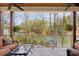 Covered porch with stone flooring, ceiling fans, and picturesque waterfront views at 176 Sunset Bay Dr, Troutman, NC 28166