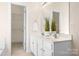 Bathroom features double sinks, a large mirror, and a doorway to the closet at 19221 Coachmans Trce, Cornelius, NC 28031