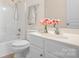 Bathroom features a shower and tub, vanity, and floral decorations at 19221 Coachmans Trce, Cornelius, NC 28031