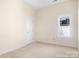 Bedroom with carpet, window, closet door, and neutral walls at 19221 Coachmans Trce, Cornelius, NC 28031