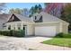 Charming home featuring a two-car garage and a well-maintained front yard with mature landscaping at 19221 Coachmans Trce, Cornelius, NC 28031