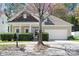 Charming single-Gathering home featuring a well-manicured lawn, attached garage, and inviting front porch at 19221 Coachmans Trce, Cornelius, NC 28031