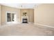 Bright living room featuring fireplace, neutral carpet, ceiling fan, and sliding glass doors at 19221 Coachmans Trce, Cornelius, NC 28031