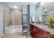 Bright bathroom featuring a granite countertop vanity, soaking tub, and tiled shower at 210 N Church St # 2305, Charlotte, NC 28202