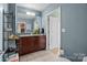 Updated bathroom featuring a granite countertop vanity, neutral tile flooring, and modern finishes at 210 N Church St # 2305, Charlotte, NC 28202
