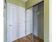 This image shows a closet with mirrored sliding doors and a white door with silver hardware at 210 N Church St # 2305, Charlotte, NC 28202