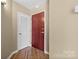 Inviting entryway features wood floors, a front door, and white door at 210 N Church St # 2305, Charlotte, NC 28202