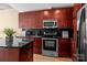 Modern kitchen featuring stainless steel appliances, black backsplash, and granite countertops at 210 N Church St # 2305, Charlotte, NC 28202