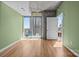 Bright living room boasts hardwood floors, a city view, and an open door at 210 N Church St # 2305, Charlotte, NC 28202