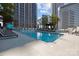 Relaxing pool area featuring lounge chairs with city buildings in the background at 210 N Church St # 2305, Charlotte, NC 28202