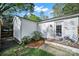 This backyard features a brick patio, a fenced in area, and landscaping creating a secluded outdoor retreat at 2314 Wolfe St, Charlotte, NC 28205
