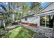An inviting backyard featuring a stone patio, a green lawn and a sliding glass door that leads inside at 2314 Wolfe St, Charlotte, NC 28205
