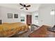 Bright bedroom featuring hardwood floors, a ceiling fan, and natural light from large windows at 2314 Wolfe St, Charlotte, NC 28205