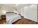 Comfortable bedroom boasts hardwood floors, closet, and floral wallpaper, offering a relaxing space at 2314 Wolfe St, Charlotte, NC 28205