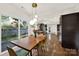 Bright dining area features a wood table, stylish lighting, and sliding doors to a private outdoor space at 2314 Wolfe St, Charlotte, NC 28205