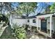 Charming front entry features a brick patio, seating area, and a brightly colored door at 2314 Wolfe St, Charlotte, NC 28205