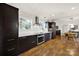Modern kitchen with stainless steel appliances, dark wood cabinets, and white subway tile backsplash at 2314 Wolfe St, Charlotte, NC 28205