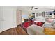 Cozy living room featuring vaulted ceilings, built-in shelving, a ceiling fan and a colorful area rug at 2314 Wolfe St, Charlotte, NC 28205