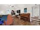 Cozy living room featuring a grand piano, eclectic decor, and hardwood floors, offering a warm and inviting atmosphere at 2314 Wolfe St, Charlotte, NC 28205