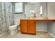 Bathroom featuring a long countertop with cabinets, patterned shower curtain, and mounted mirror at 309 River Clay Rd, Fort Mill, SC 29708